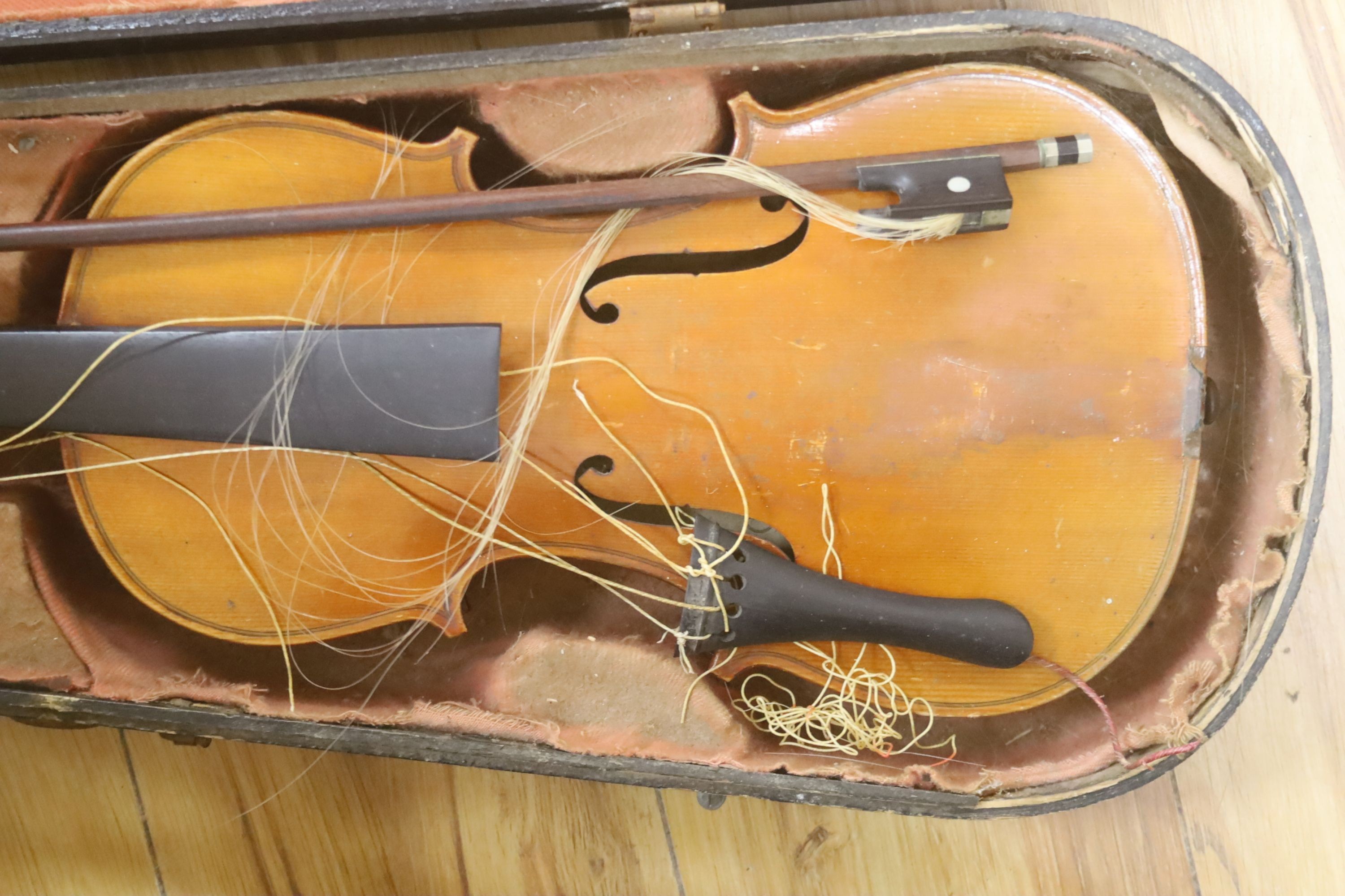 A Stradivarius copy violin and two bows and another bow, both cased, backs 33cm and 30cm